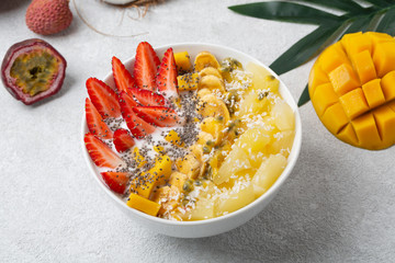 Healthy Breakfast smoothie bowl with yogurt, tropical fruits and Chia seeds.