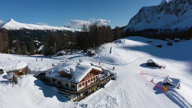 Skiers having lunch break and Apres Ski party on Ski House - Aerial View, Sexten Italy