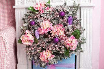 cristmas wreath with flowers and beads hanging on the wall
