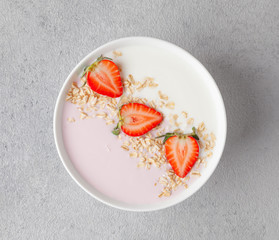 Berry smoothie bowl with yogurt, muesli and strawberries. Healthy and delicious Breakfast.