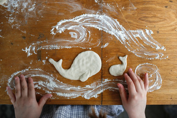 Girl child sculpts from salt dough, creativity