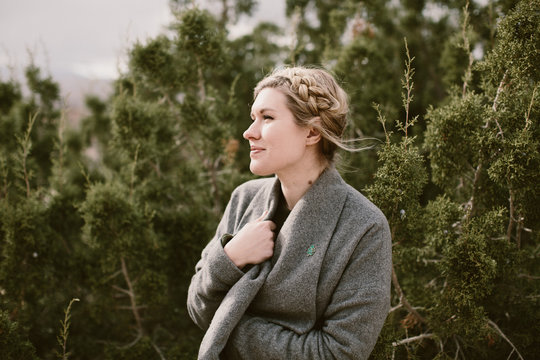 Young Woman Bundling Up In Her Sweater