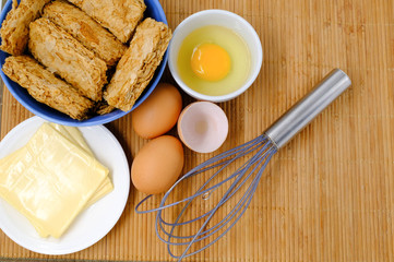 ingredients and tools to make a cake, butter, cereal and eggs
