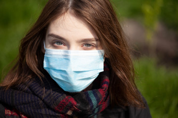 Young Girl on the city street wearing face mask protective for spreading of disease virus SARS-CoV-2