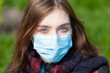 Young Girl on the city street wearing face mask protective for spreading of disease virus SARS-CoV-2