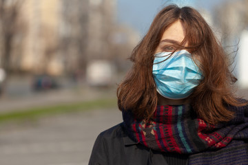 Young Girl on the city street wearing face mask protective for spreading of disease virus SARS-CoV-2