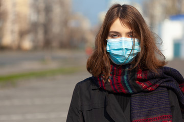 Young Girl on the city street wearing face mask protective for spreading of disease virus SARS-CoV-2