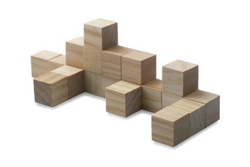 Selective focus of toy wooden cube isolated on a white background.