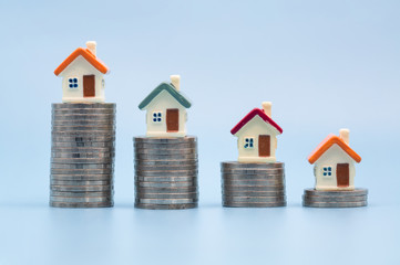 Mini house on stack of coins,Money and house,  Mortgage, Savings money for buy house and loan to business investment for real estate concept. Invesment and Risk Management.