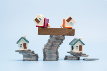 Mini house on stack of coins,Money and house,  Mortgage, Savings money for buy house and loan to...