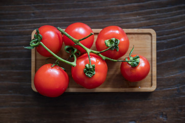 Six fresh tomatoes on the desktop