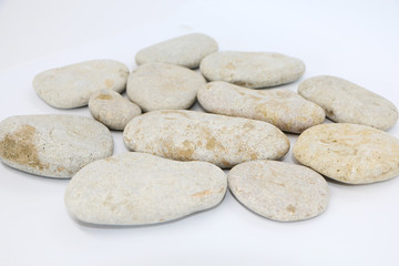 Background - gray sea stones laid out on a white background