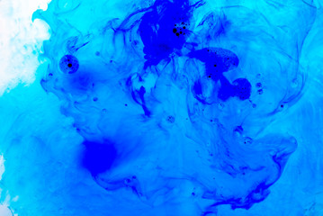 Abstract blured background from blue ink, milk and oil