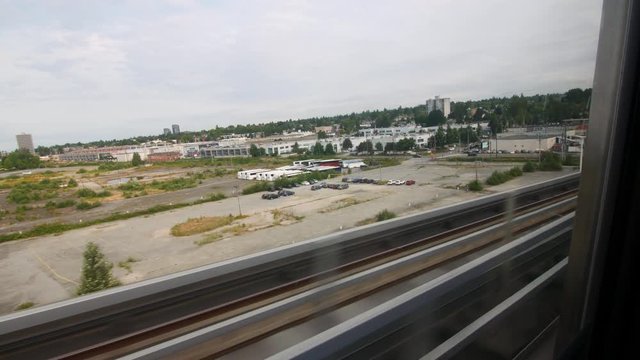 Window view of traveling on the skytrain across vancover