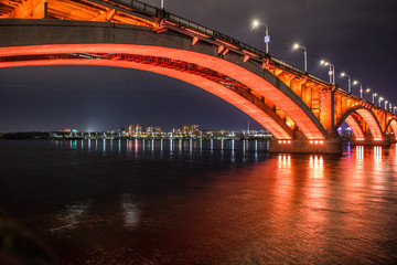Fototapeta premium large bridge with bright illumination at night in Krasnoyarsk Siberia, Russia