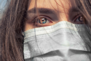 Young Girl on the city street wearing face mask protective for spreading of disease virus SARS-CoV-2