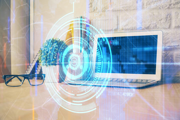 Double exposure of desktop computer and technology theme hologram. Concept of software development.