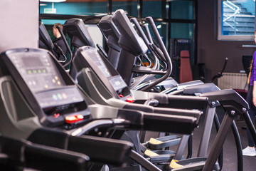 Modern ellipsoid trainer in a dark gym