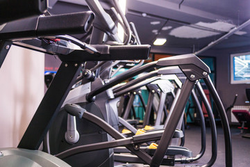 Modern ellipsoid trainer in a dark gym