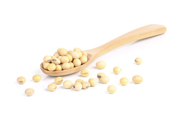 Soy beans on a wooden spoon isolated on a white background