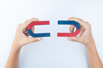 hand holding a magnet isolated on white background