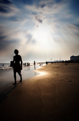 silhouette of a man walking on the beach