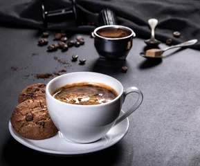 Fotobehang Coffee cup, cookies and utensils for coffee maker on black background © nikilitov