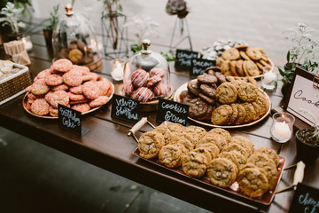 dessert table of cookies with floral & candle decor