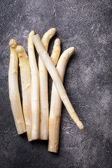 Fresh, white asparagus against a dark background. Healthy eating concept.