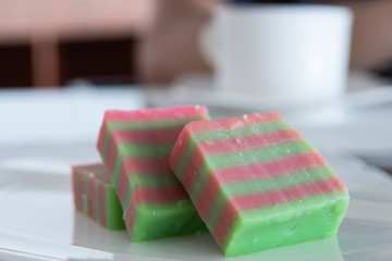 Dessert called Kuih Lapis (English layer cake),also known as Kue, with eight pink and green colored layers. Bite sized steamed layered cake widely used in Indonesia, Malaysia and Singapore. Soft focus