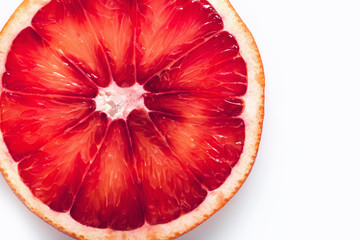 Red blood orange slice on white background. Close-up