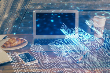 Desktop computer background in office and big town buildings hologram drawing. Double exposure. Smart city concept.