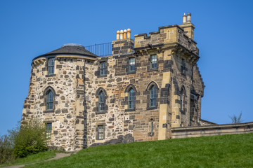 Fototapeta na wymiar View of a classic stone monument house on Calton Hill, blue sky as background