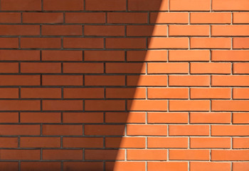 New red brick wall. A shadow from the roof falls on the brick wall.