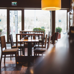Modern cafe interior in wooden style in sunlight