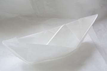 origami paper boat on white paper background