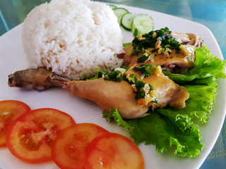 Cambodian chicken leg steak served with vegetables and steamed rice