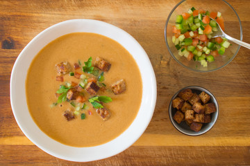 Food photography of a chilled Spanish gazpacho soup in a white bowl.