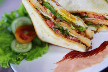 Sandwich with beef,tomato and lettuce on platter. A breakfast menu photography.