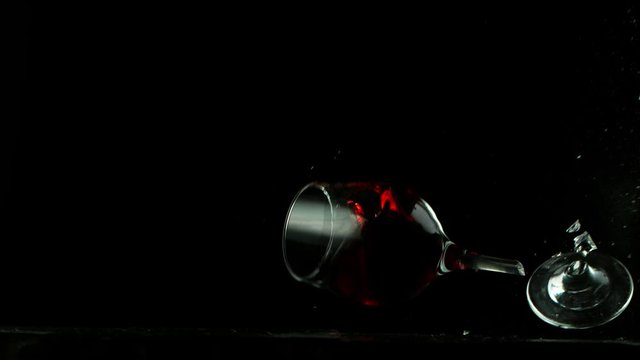 Super slow motion of falling glass of red wine, being destructed. Filmed on high speed cinema camera, 1000 fps.