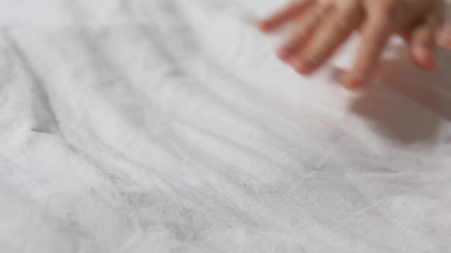 household, housework and cleaning concept - hands of woman making bed linen