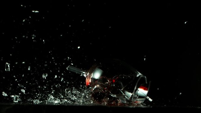 Super slow motion of falling glass of red wine, being destructed. Filmed on high speed cinema camera, 1000 fps.
