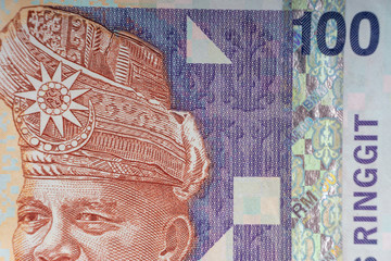Hundred Malaysia Ringgit MYR or 100 Malaysia Ringgit Cash Banknotes macro view. Selective focus, crop fragment and Business Concept.