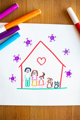 Little child's drawing with color pens around, representing her family and pets happy at home...