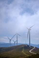 windmills at the top of a mountain whith blue sky