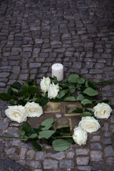 Stolpersteine (stumbling stone) with roses	