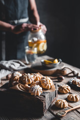 Man pours Hot tea with slices of fresh grapefruit on wooden tablet. Healthy drink, Eco, vegan.