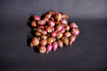 onion on a black background.  shallots are used for seasoning