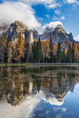 Lake Antorno in Dolomite Alps and colorful trees with reflections in autumn season, Italy