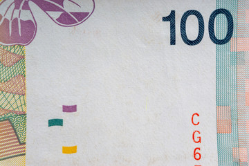 Hundred Malaysia Ringgit MYR or 100 Malaysia Ringgit Cash Banknotes macro view. Selective focus, crop fragment and Business Concept.